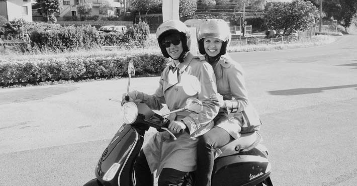 A young couple ready for a Vespa journey starting from Pisa